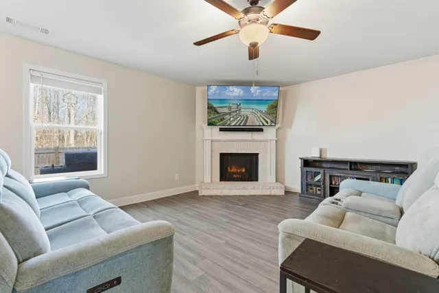 a living room with furniture and a fireplace