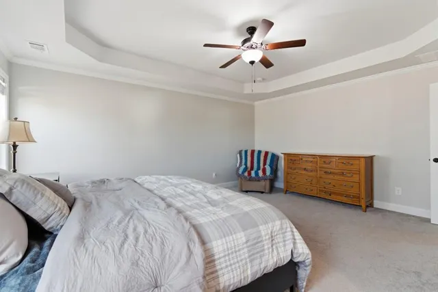 a bed room with a bed and a ceiling fan