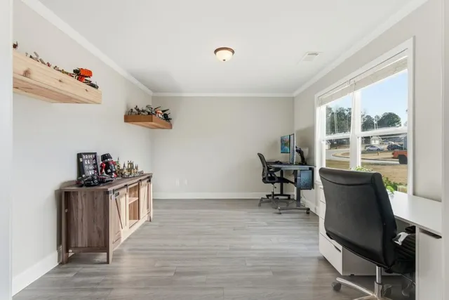 a view of a workspace with furniture and a window