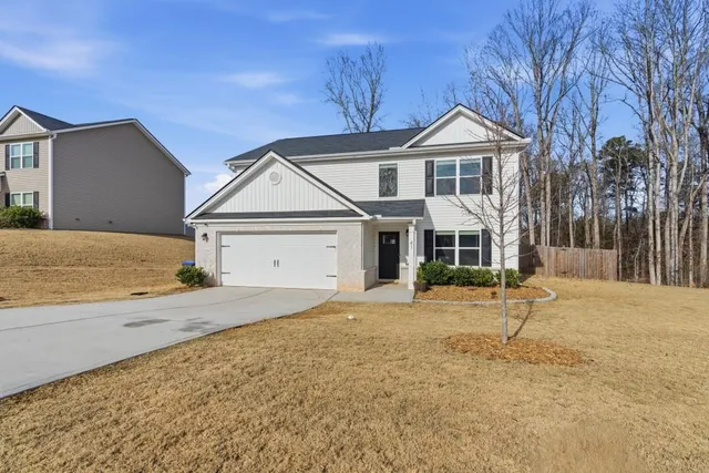 a front view of a house with a yard and garage