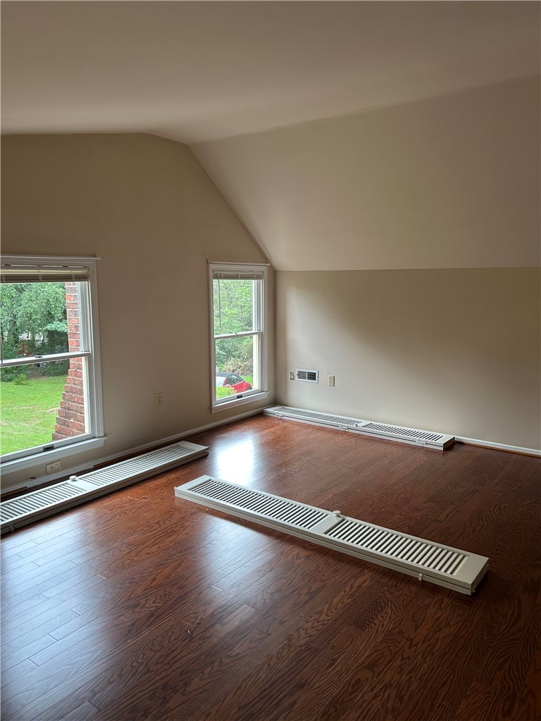 110 North Broad Street Pendleton, SC 29670 - Photo 24 of 32 Rich hardwood flooring complements the naturally illuminated walls of this adaptable space.