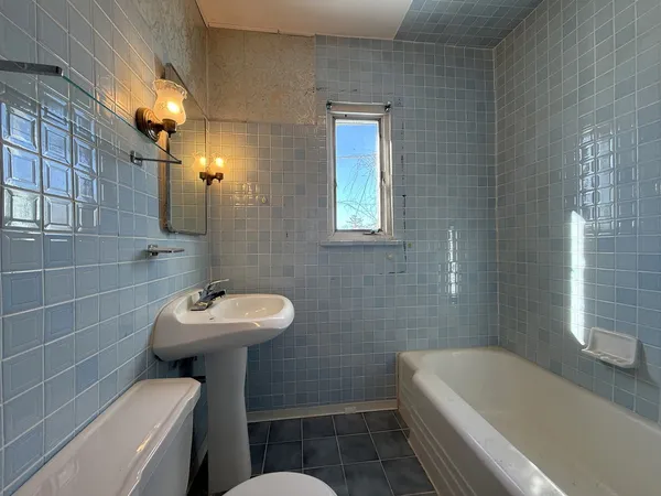 a bathroom with a sink a toilet and bathtub