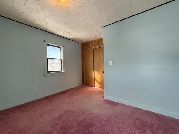 a view of empty room with wooden ceiling