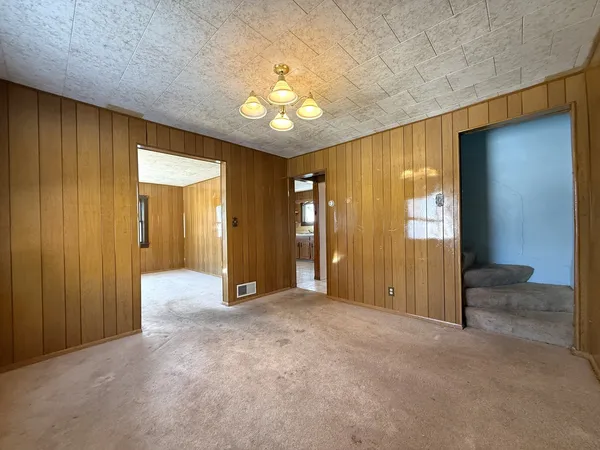 wooden view of an empty room with a bathroom