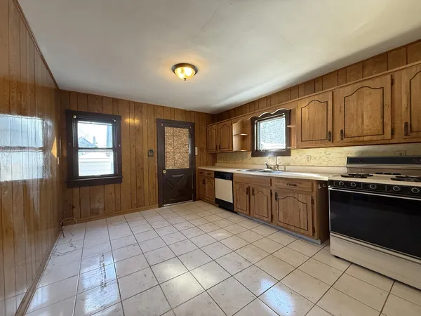 a kitchen with stainless steel appliances granite countertop a refrigerator stove and sink