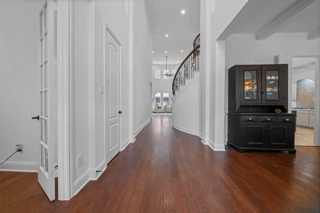 a view of a hallway with wooden floor and stairs