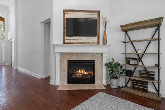 a living room with a fireplace and a potted plant