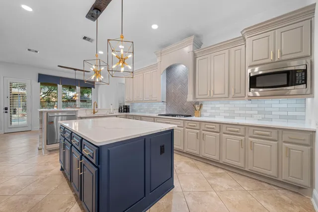 a kitchen with cabinets and chandelier