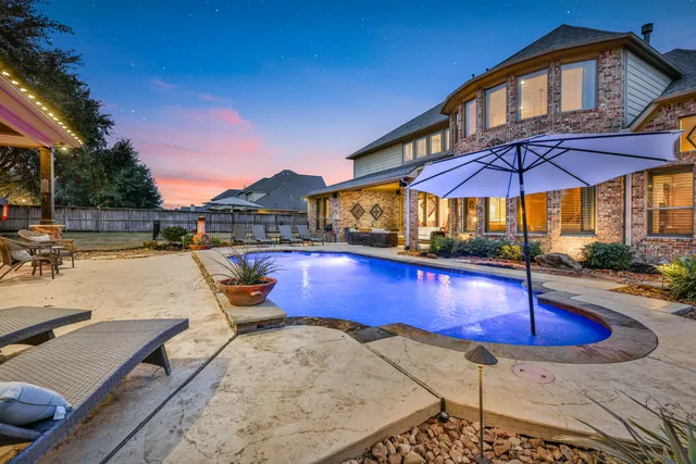 a swimming pool with an outdoor seating
