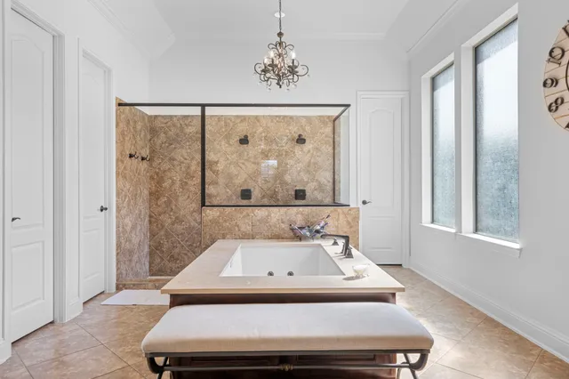 a bathroom with a sink and mirror with bathtub