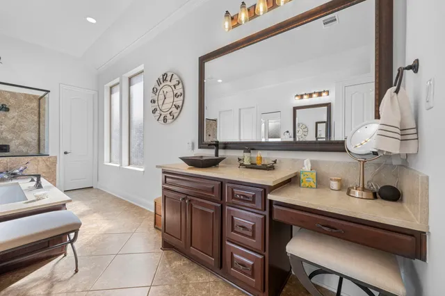 a room with a table chairs and a painting on the wall