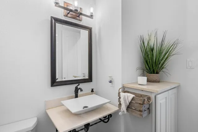 a bathroom with a sink a mirror and vanity