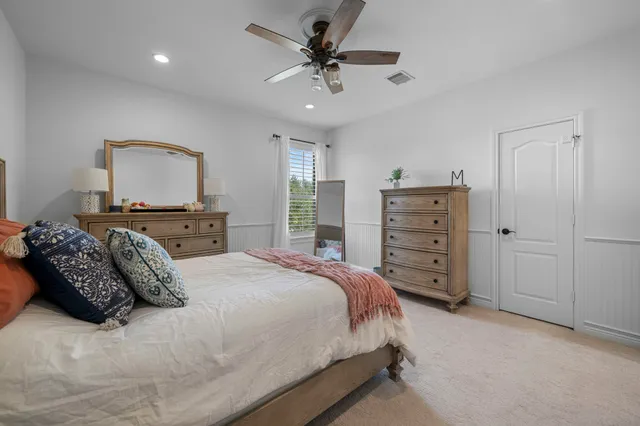 a bedroom with a bed and a dresser