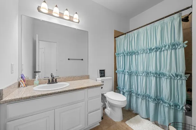 a bathroom with a toilet a sink and a mirror