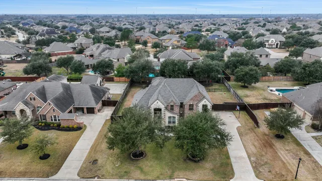 an aerial view of multiple houses with yard