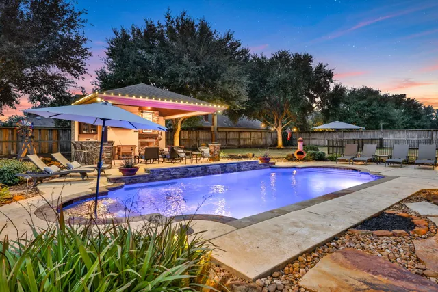 a view of a swimming pool with a patio