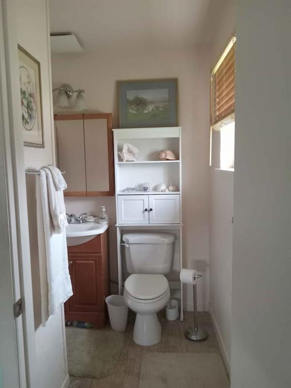 408 East Johnston Street Rotan, TX 79546 - Photo 16 of 18 a bathroom with a toilet and a shower