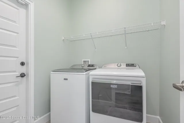 an empty room with wooden floor window and ceiling fan