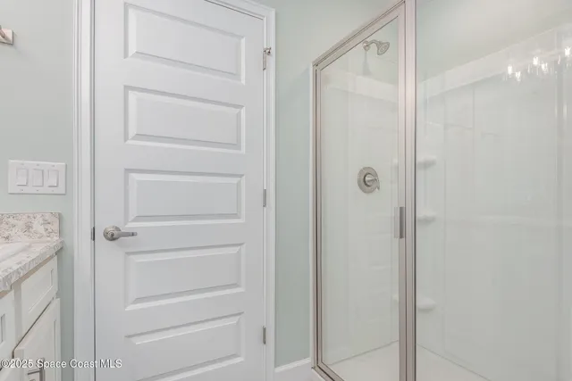 a bathroom with a granite countertop sink toilet a mirror and shower