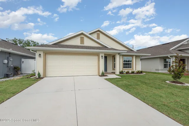 a kitchen with granite countertop white cabinets stainless steel appliances and a sink