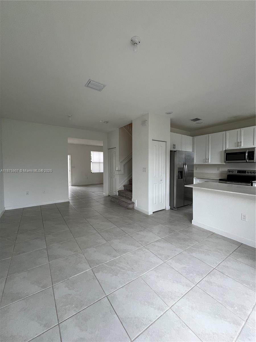 10008 Southwest 228th Terrace Miami, FL 33190 - Photo 12 of 46 a view of a kitchen with electric appliances