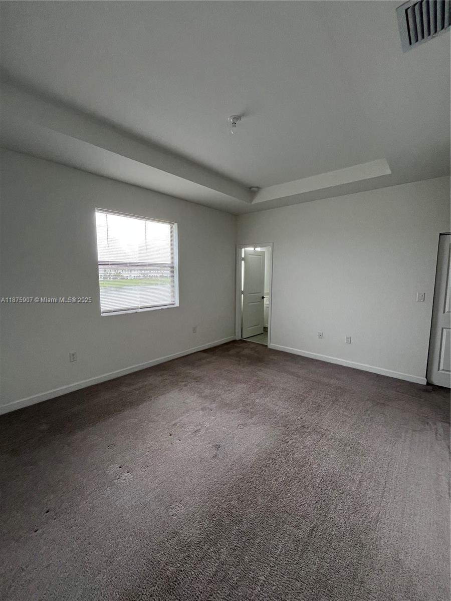 10008 Southwest 228th Terrace Miami, FL 33190 - Photo 17 of 46 a view of an empty room with a window