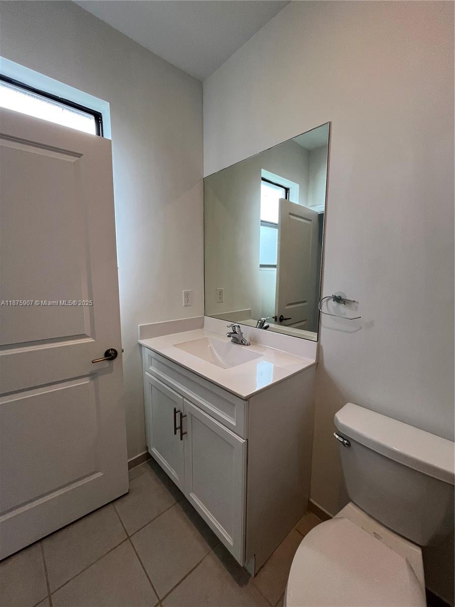 10008 Southwest 228th Terrace Miami, FL 33190 - Photo 20 of 46 a bathroom with a sink toilet and mirror