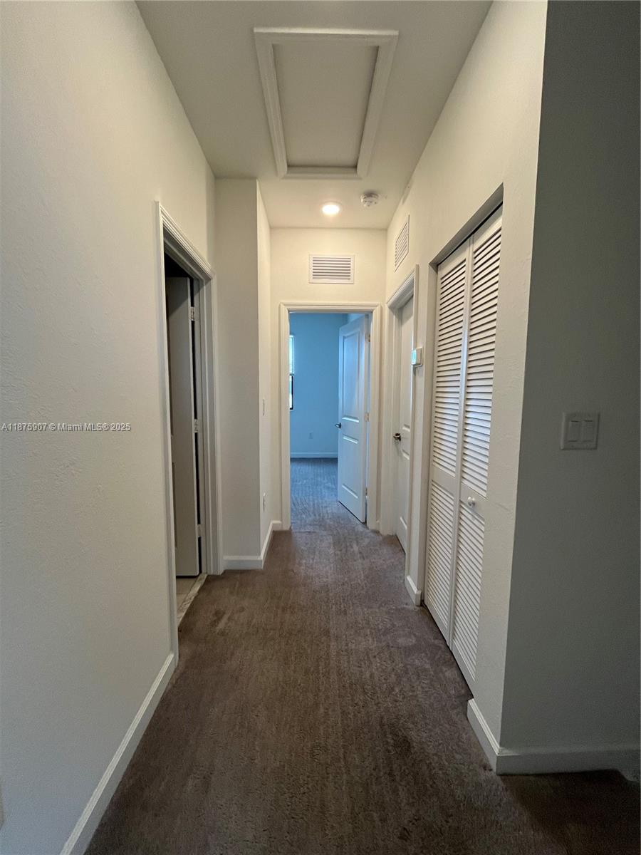 10008 Southwest 228th Terrace Miami, FL 33190 - Photo 21 of 46 a view of a hallway with wooden shelves