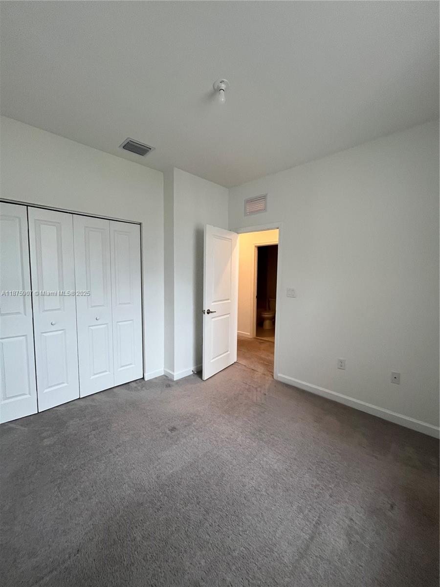 10008 Southwest 228th Terrace Miami, FL 33190 - Photo 22 of 46 a view of an empty room and a window