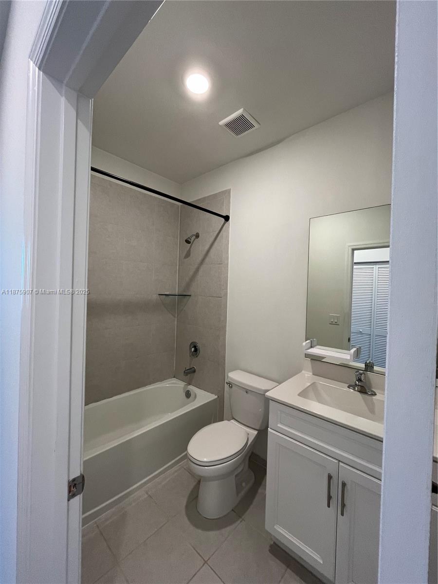 10008 Southwest 228th Terrace Miami, FL 33190 - Photo 24 of 46 a bathroom with a bathtub shower sink vanity and toilet