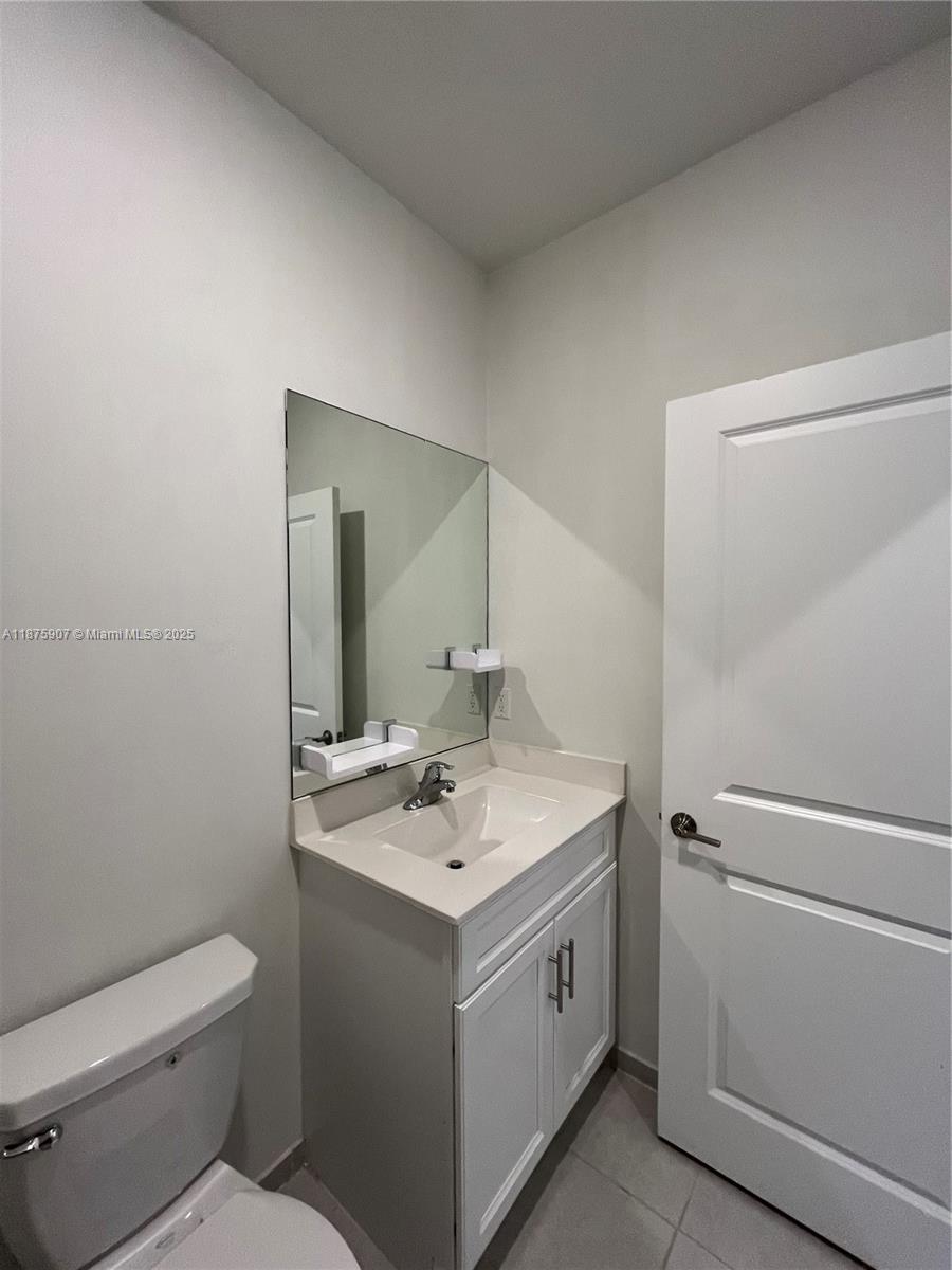 10008 Southwest 228th Terrace Miami, FL 33190 - Photo 25 of 46 a bathroom with a toilet sink and mirror
