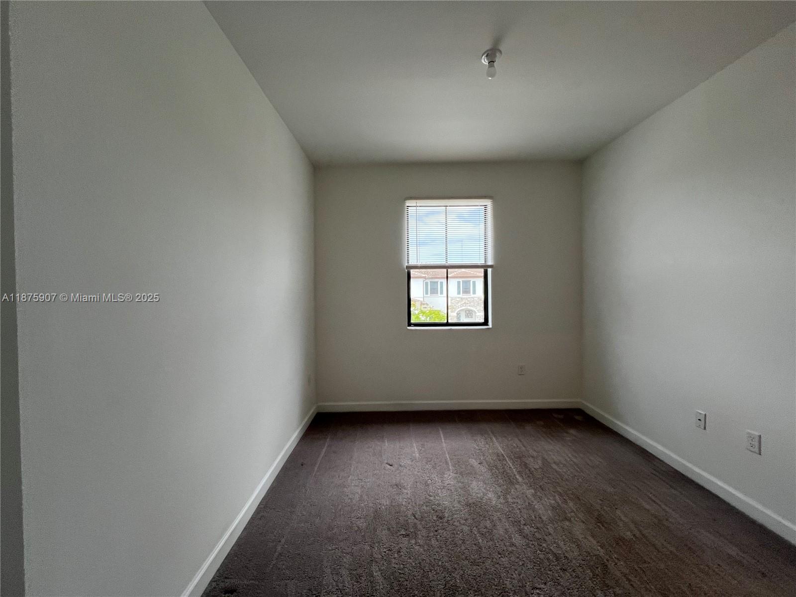10008 Southwest 228th Terrace Miami, FL 33190 - Photo 28 of 46 an empty room with a window