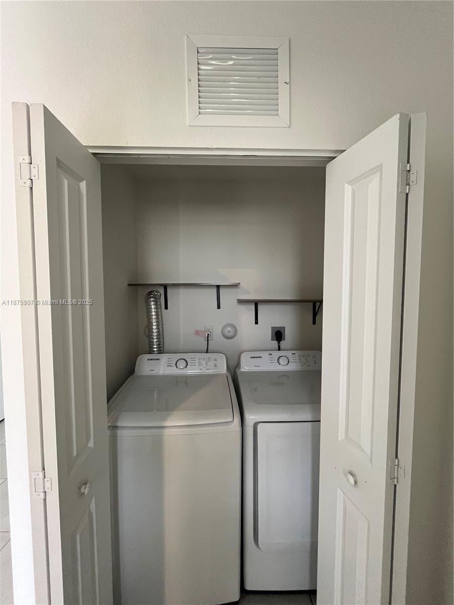 10008 Southwest 228th Terrace Miami, FL 33190 - Photo 31 of 46 a utility room with dryer and washer