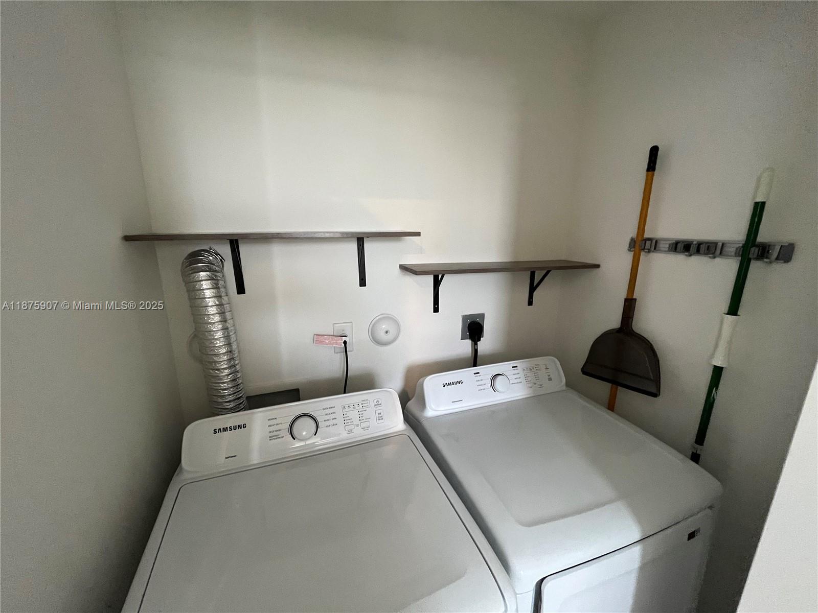 10008 Southwest 228th Terrace Miami, FL 33190 - Photo 32 of 46 a utility room with dryer and washer