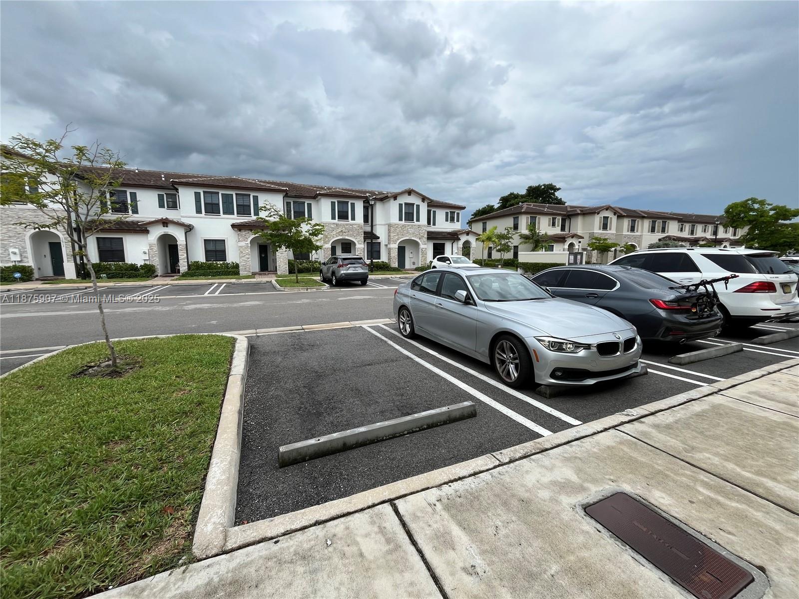 10008 Southwest 228th Terrace Miami, FL 33190 - Photo 34 of 46 a view of parking with cars parked