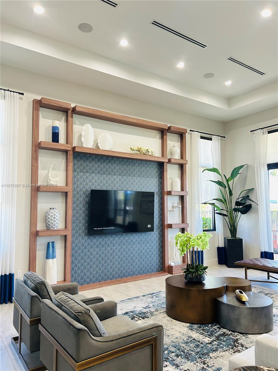 10008 Southwest 228th Terrace Miami, FL 33190 - Photo 35 of 46 a living room with furniture and a flat screen tv