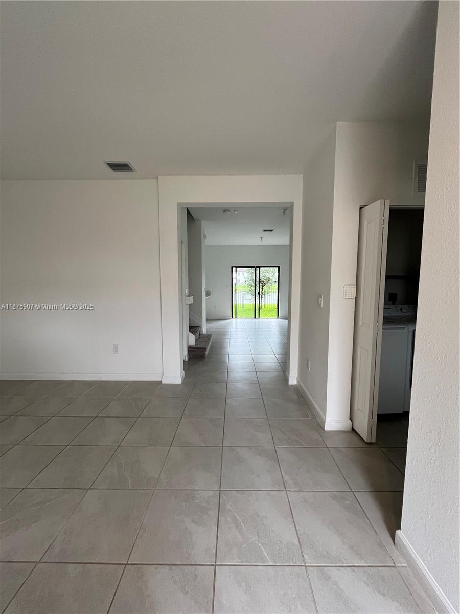 10008 Southwest 228th Terrace Miami, FL 33190 - Photo 4 of 46 a view of an empty room and fire place