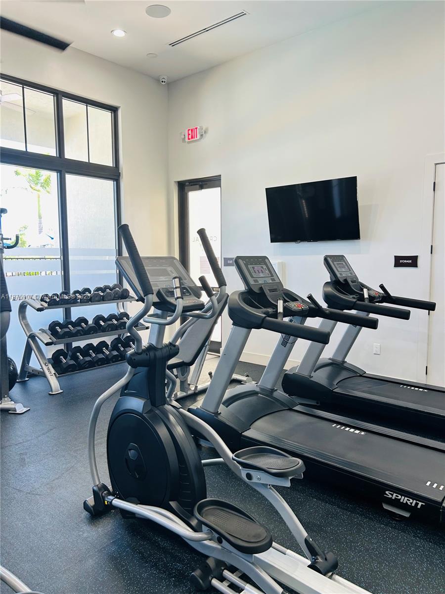 10008 Southwest 228th Terrace Miami, FL 33190 - Photo 43 of 46 a gym area with wooden floor and shoes