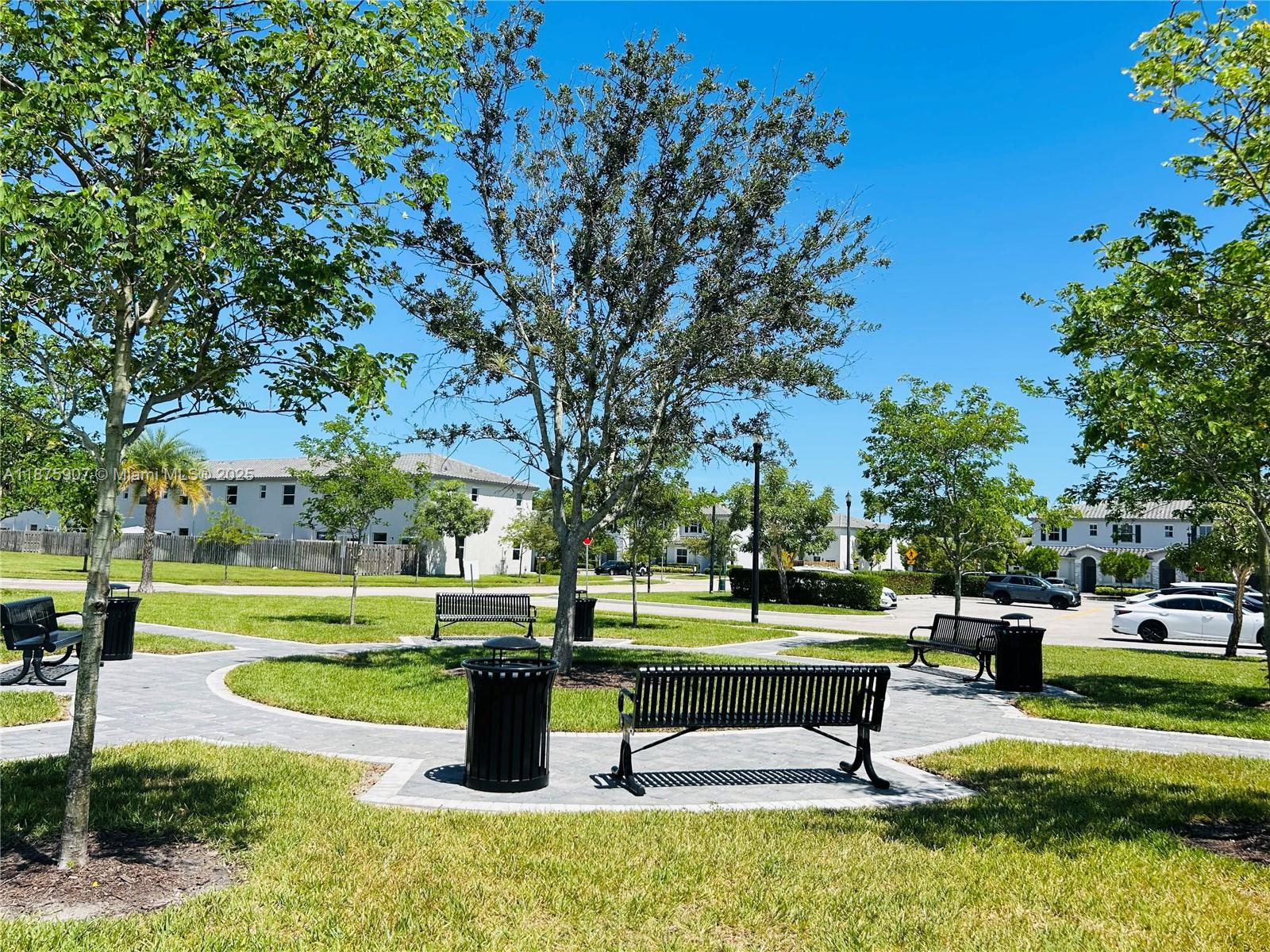 10008 Southwest 228th Terrace Miami, FL 33190 - Photo 45 of 46 a park bench sitting in the middle of a park