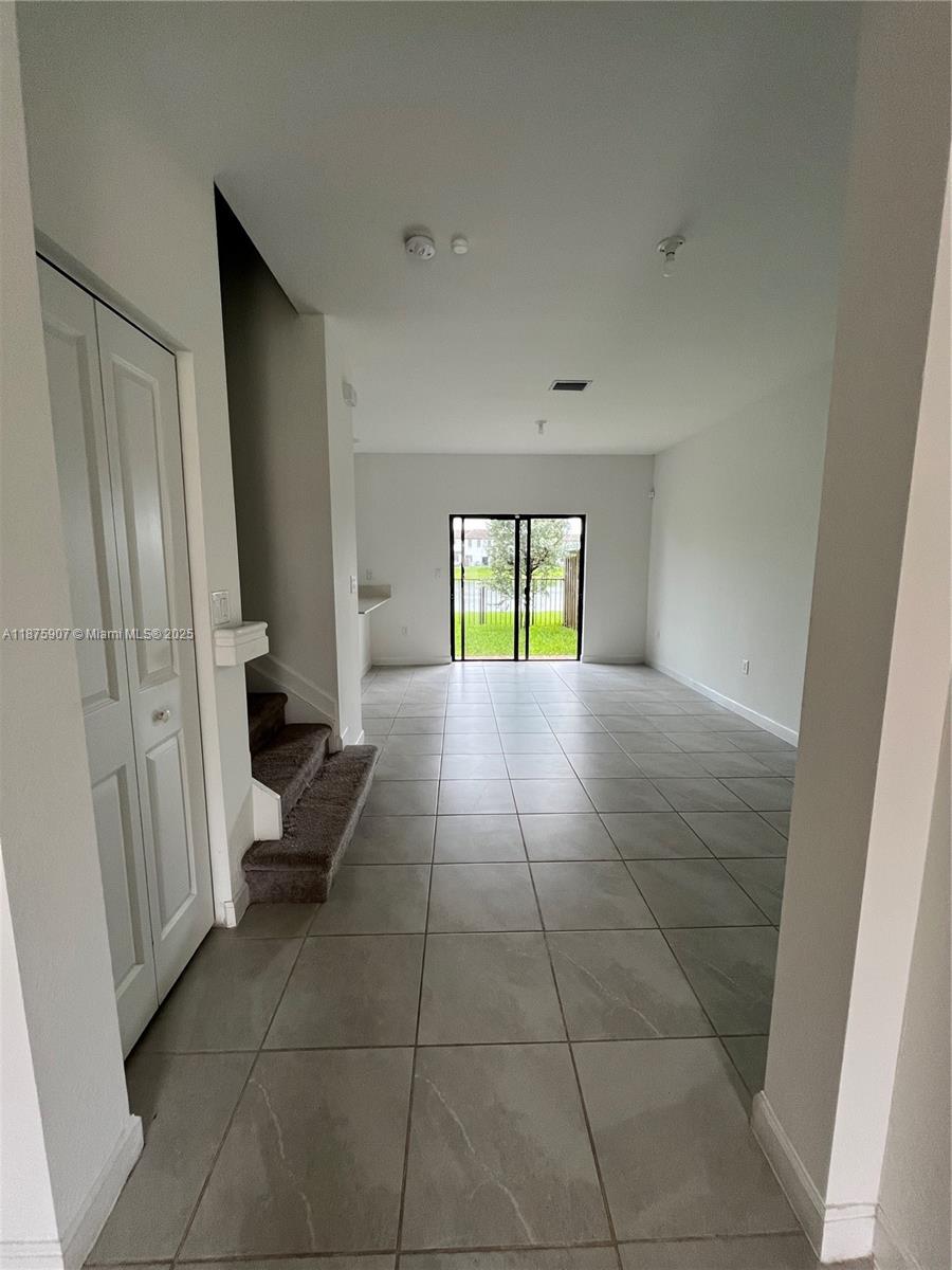 10008 Southwest 228th Terrace Miami, FL 33190 - Photo 8 of 46 a view of an empty room and a window