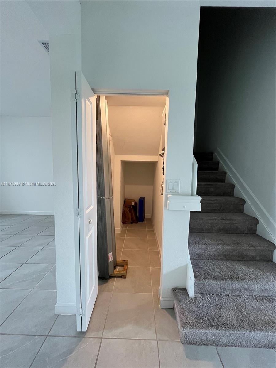 10008 Southwest 228th Terrace Miami, FL 33190 - Photo 9 of 46 a view of a hallway to an entryway with fireplace