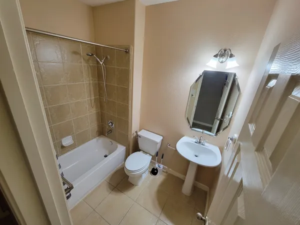 a bathroom with a granite countertop sink a large mirror and shower