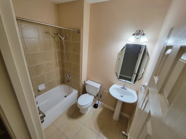 a bathroom with a granite countertop sink a large mirror and shower