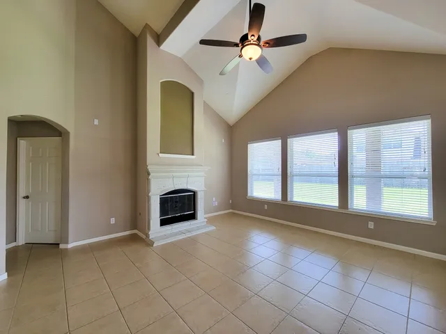 a view of entryway and hall with a fireplace
