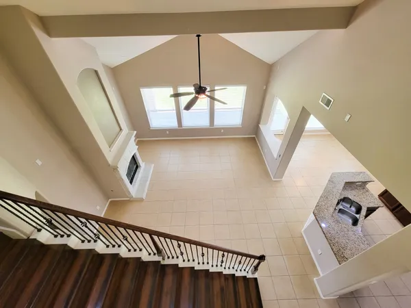 a kitchen with stainless steel appliances granite countertop a refrigerator a stove and a sink