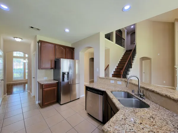 a kitchen with stainless steel appliances granite countertop a stove and a sink
