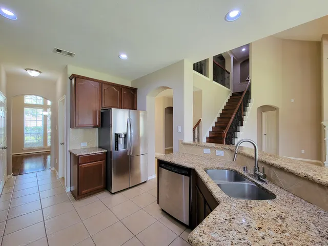 a kitchen with stainless steel appliances granite countertop a stove and a sink