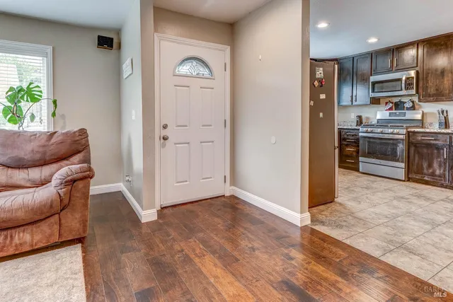 a kitchen with stainless steel appliances granite countertop a refrigerator and a stove top oven