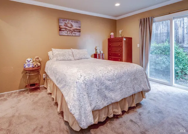 a bed sitting in a bedroom next to a window