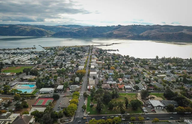an aerial view of residential building and lake
